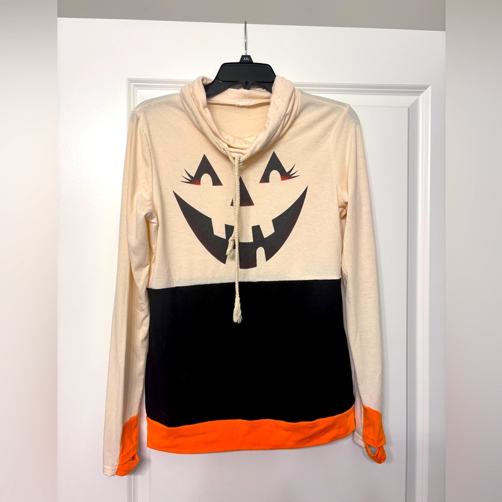 Hooded pullover size S. Pumpkin face on front.  Thinner material